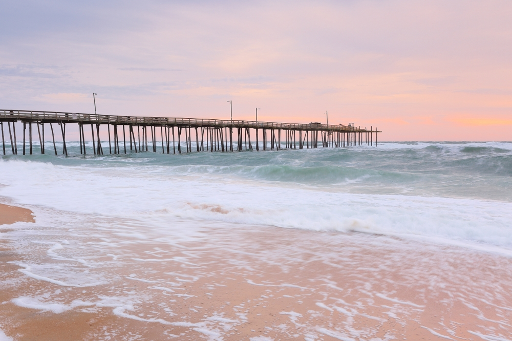 Waves rolling in toward the Nags Head Pier on the Outer Banks at sunrise